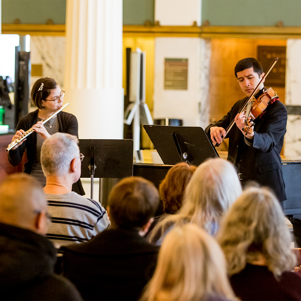 two musicians playing for community event