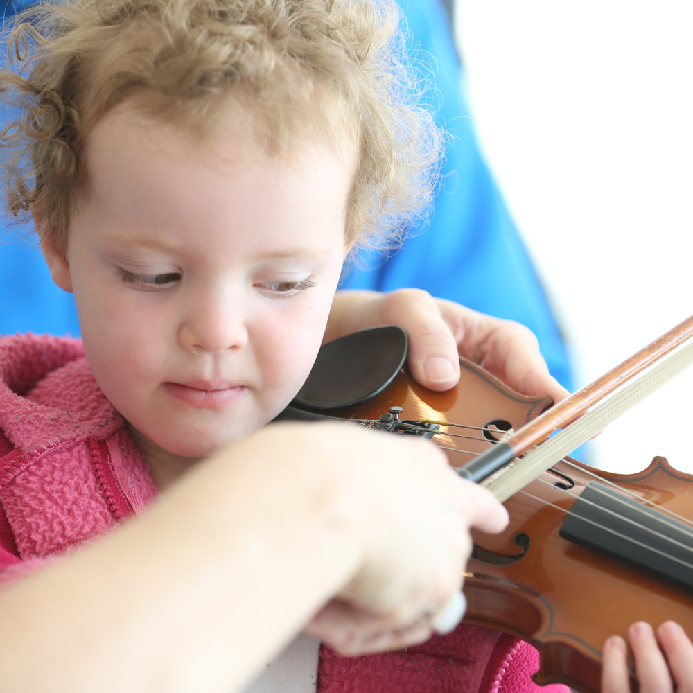 child learning to play violin