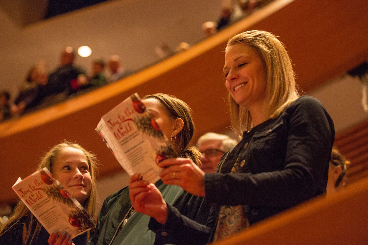 audience members holding concert programs