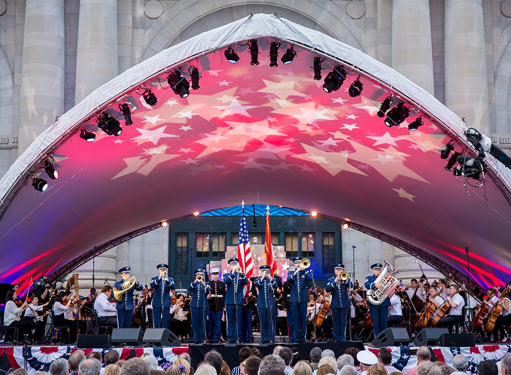 Photo of Armed Salute with the Kansas City Symphony on an outdoor stage in front of Union Station in Kansas City at Bank of America Celebration at the Station